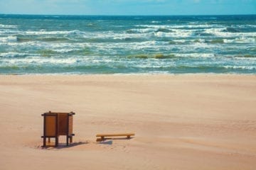 Deserted beach, bench on the beach